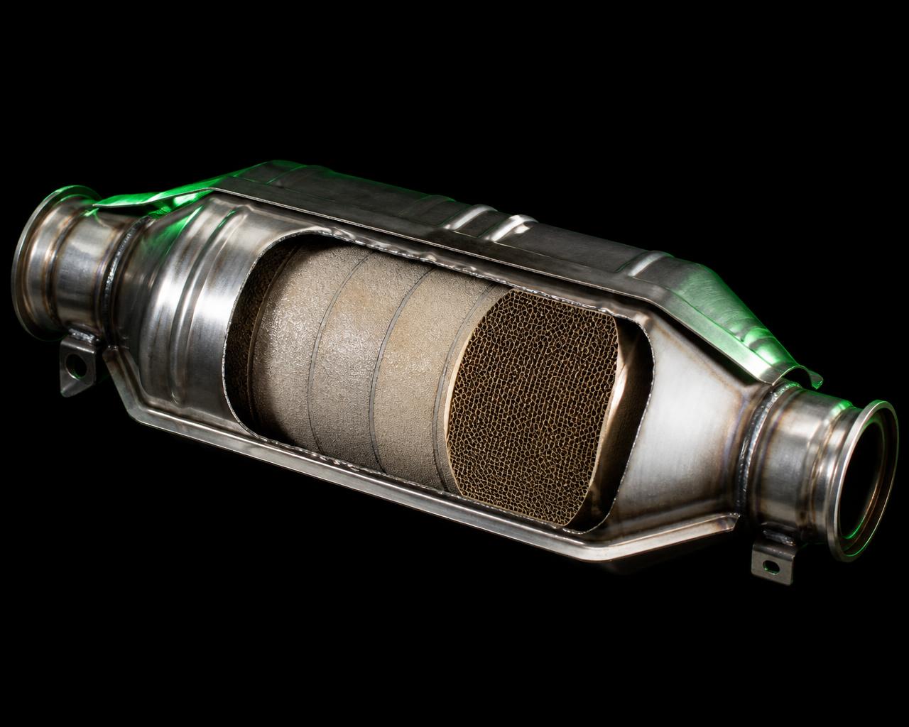 Cut-open automotive catalytic converter showing the honeycomb ceramic core that holds platinum, palladium and rhodium